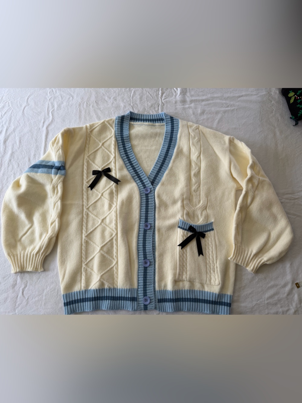 Amazon Cream Knit Cardigan with Light Blue Trim and Black Ribbon Bows